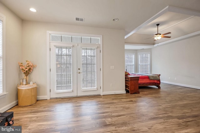 doorway with hardwood / wood-style floors, ceiling fan, and french doors