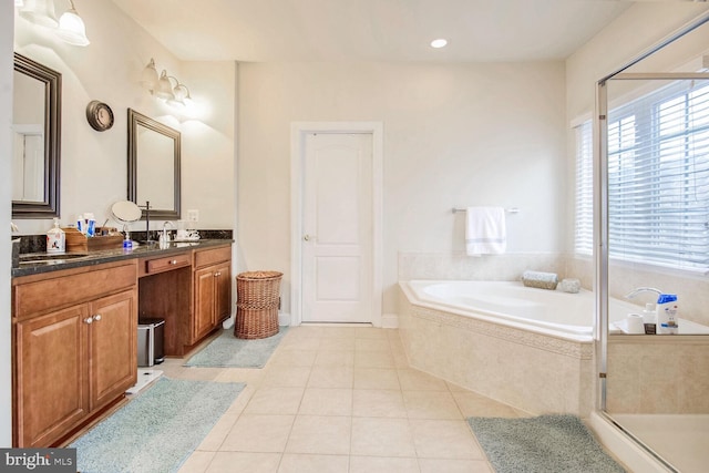 bathroom featuring vanity, independent shower and bath, and tile patterned flooring