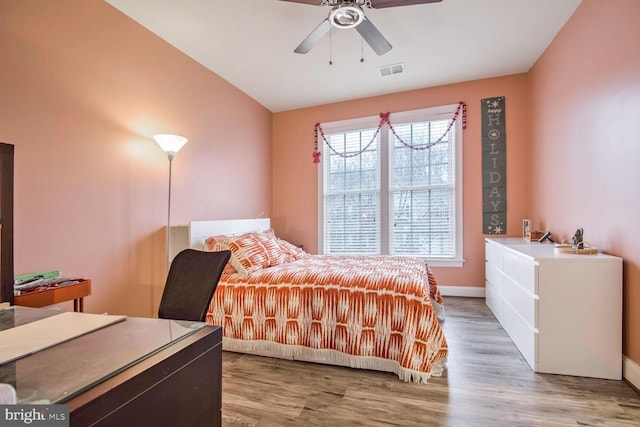 bedroom with ceiling fan and light wood-type flooring