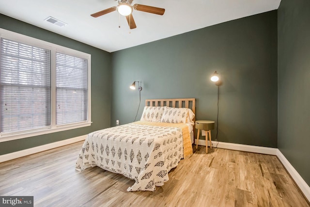 bedroom with ceiling fan and light hardwood / wood-style flooring