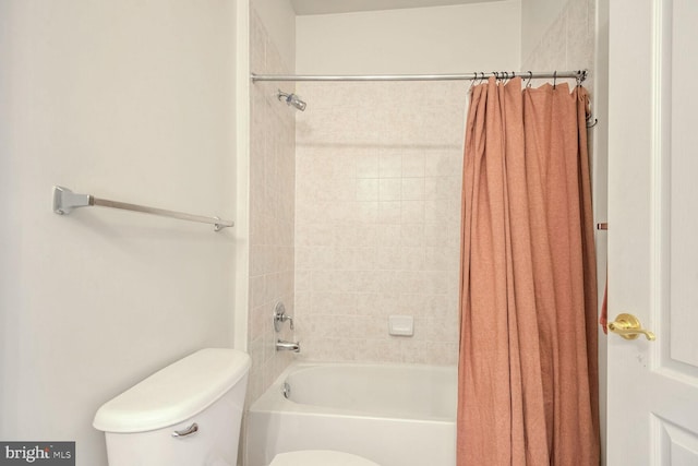 bathroom with shower / bath combo and toilet