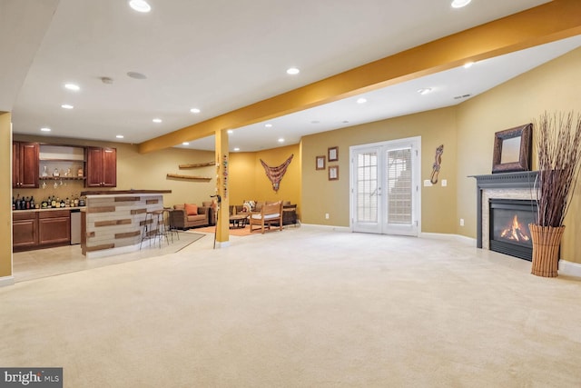 carpeted living room featuring french doors and bar