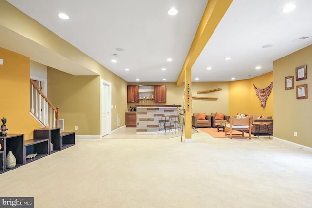 living room with light colored carpet and indoor bar