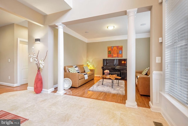 interior space featuring ornamental molding, decorative columns, and light tile patterned flooring