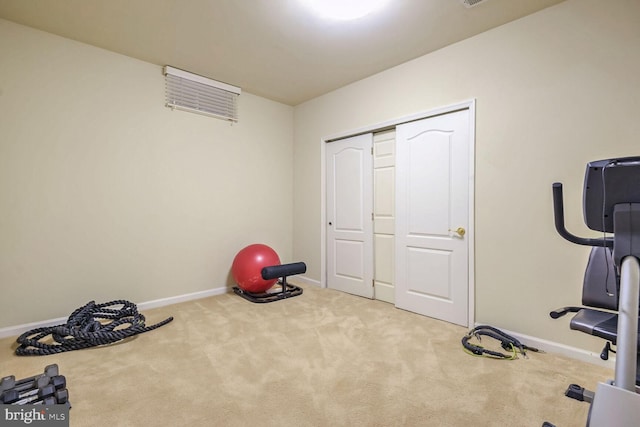 exercise room with light carpet