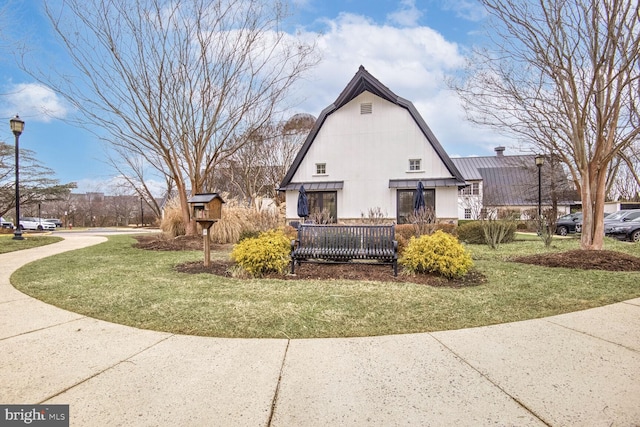 view of side of property with a lawn