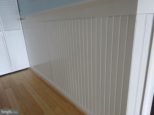 corridor featuring hardwood / wood-style flooring and radiator heating unit