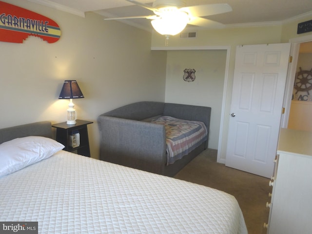 carpeted bedroom featuring ceiling fan and ornamental molding