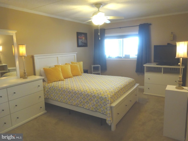 carpeted bedroom with crown molding and ceiling fan