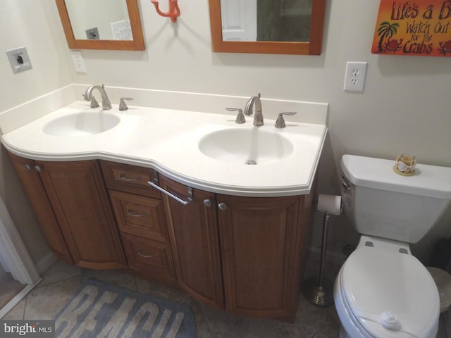 bathroom featuring tile patterned flooring, vanity, and toilet