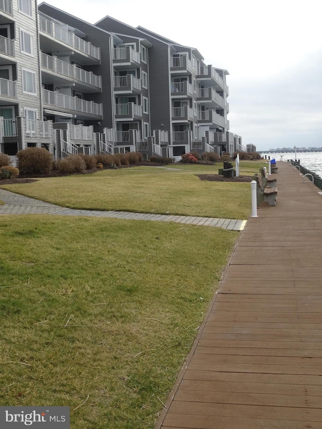 view of home's community featuring a water view and a lawn