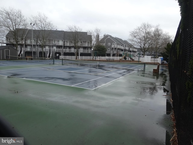 view of sport court with a playground