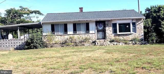 view of front of house featuring a carport and a front yard