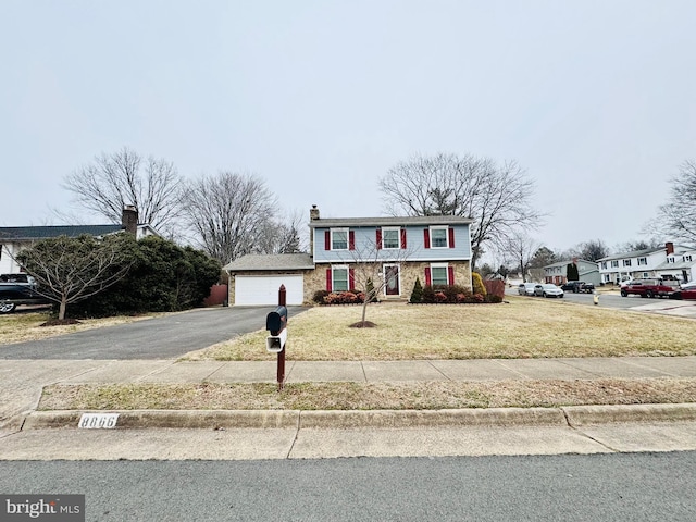 view of front facade with a garage and a front yard