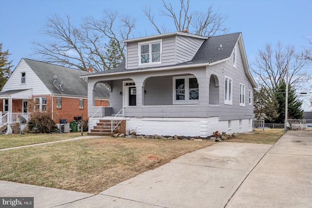 bungalow-style house with a front yard and a porch