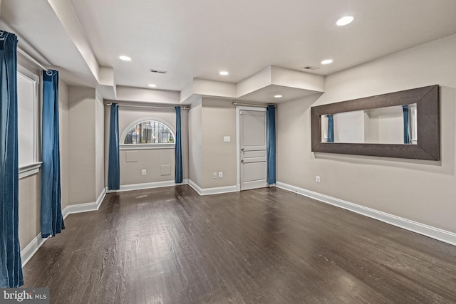 interior space featuring recessed lighting, baseboards, and wood finished floors