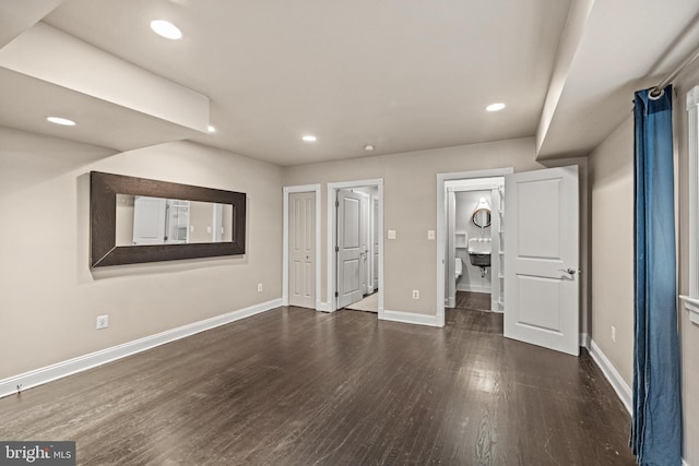 unfurnished bedroom featuring ensuite bath, recessed lighting, wood finished floors, and baseboards