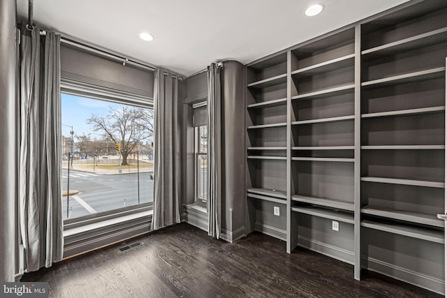 interior space with dark wood finished floors and visible vents