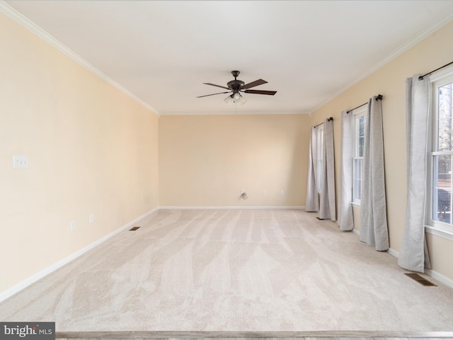 carpeted empty room featuring crown molding and ceiling fan