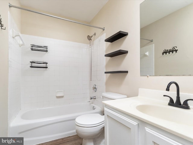 full bathroom featuring toilet, vanity, tiled shower / bath, and wood-type flooring