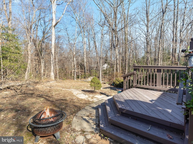 wooden terrace with an outdoor fire pit