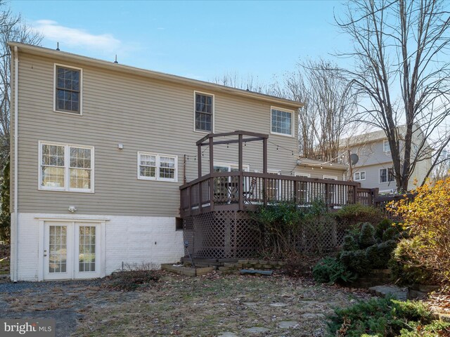 rear view of property featuring a deck