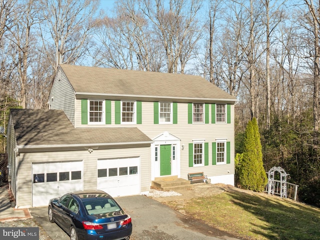 view of front of property featuring a front yard and a garage