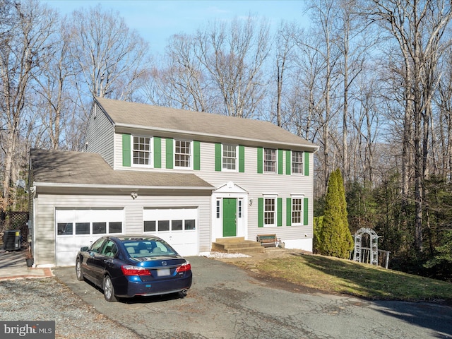 view of front of home featuring central AC unit and a garage