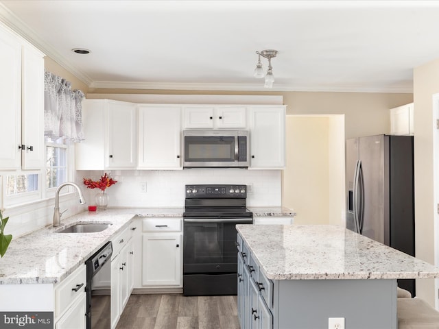 kitchen featuring sink, white cabinetry, a kitchen island, black appliances, and light stone countertops