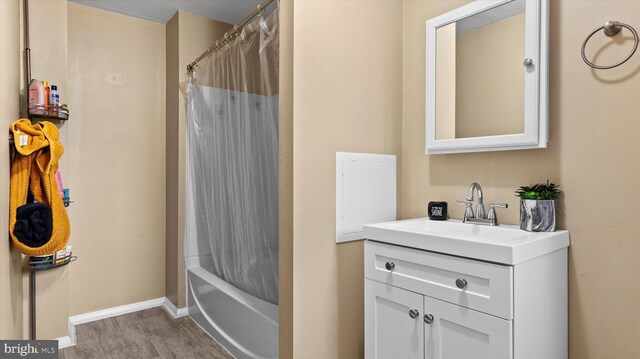 bathroom with vanity, wood-type flooring, and shower / bath combination with curtain