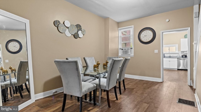 dining space with dark hardwood / wood-style flooring