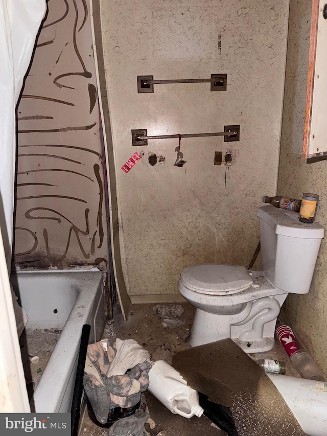 bathroom featuring a bathing tub and toilet