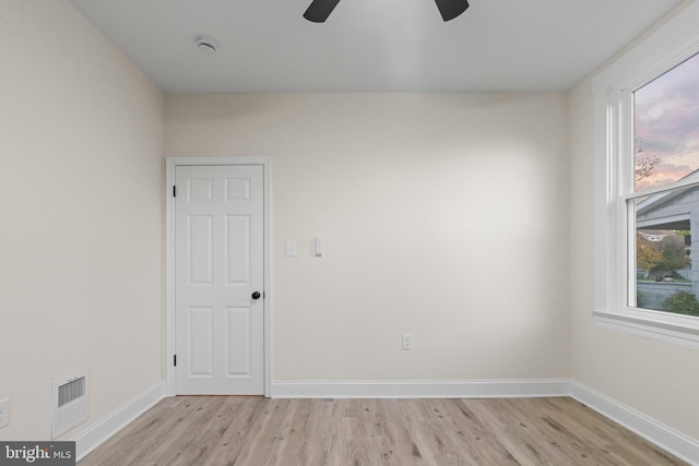 unfurnished room with ceiling fan and light wood-type flooring