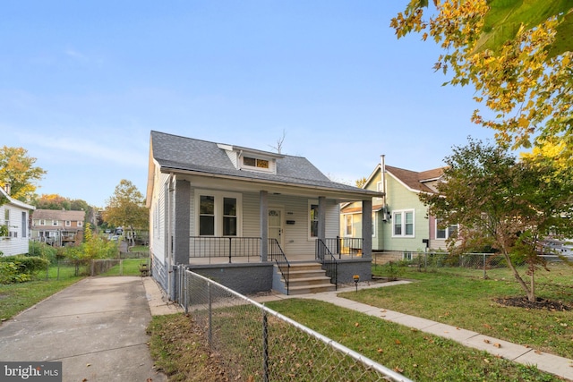 bungalow with a front lawn and covered porch