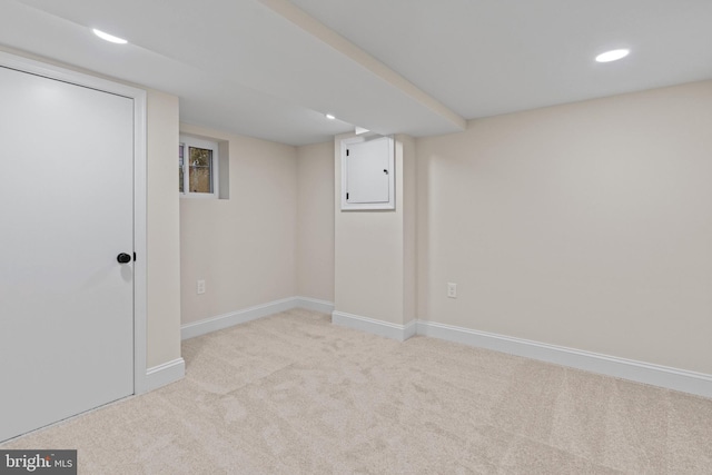 basement with light colored carpet and electric panel