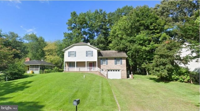 view of front facade featuring a garage, driveway, a front lawn, and a porch