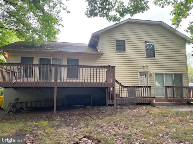 rear view of property featuring a deck