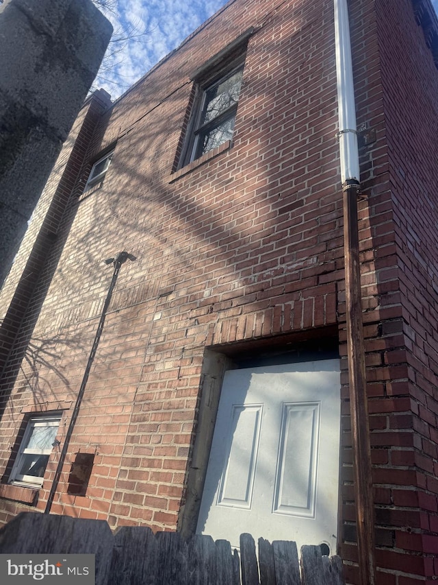 view of side of property featuring brick siding