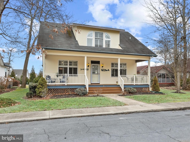 view of front of property with a front lawn and covered porch