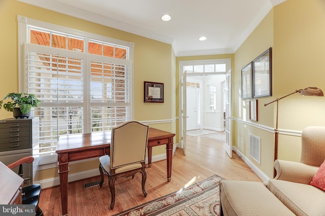 home office featuring baseboards, visible vents, ornamental molding, and light wood-type flooring