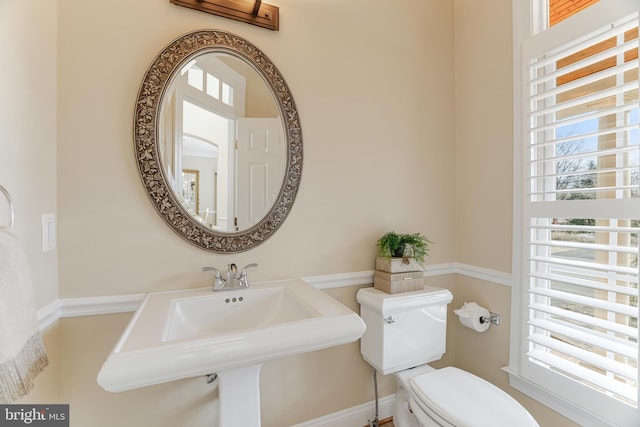 half bath with a sink and toilet