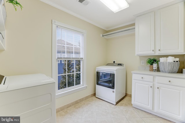 clothes washing area featuring cabinet space, baseboards, light tile patterned floors, visible vents, and ornamental molding
