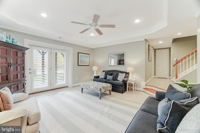 living room with stairway, a raised ceiling, a ceiling fan, and recessed lighting