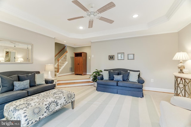living area featuring stairs, a raised ceiling, baseboards, ornamental molding, and recessed lighting