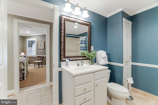 full bath featuring crown molding, tile patterned floors, baseboards, vanity, and toilet