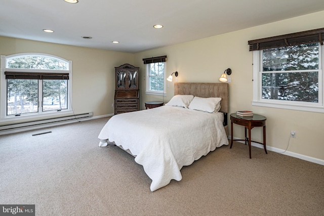 carpeted bedroom with a baseboard heating unit