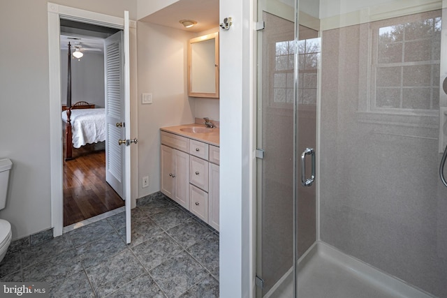 bathroom with tile patterned floors, toilet, vanity, and a shower with shower door