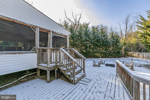 snow covered deck with a sunroom, ceiling fan, and an outdoor fire pit