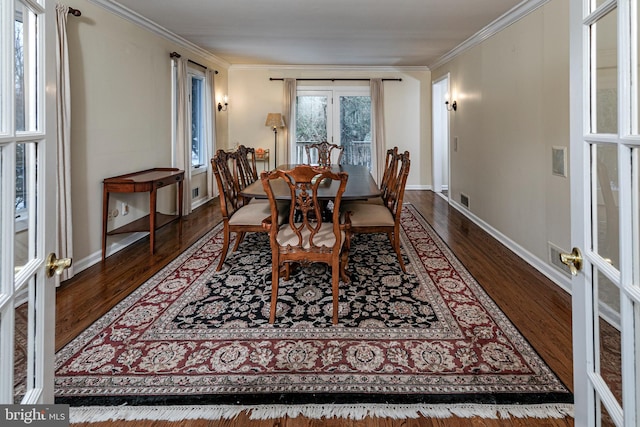 dining space with crown molding, wood finished floors, french doors, and baseboards