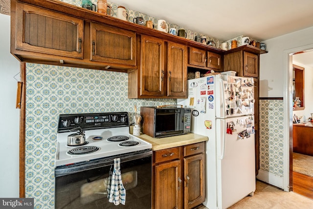 kitchen featuring range with electric cooktop and white fridge